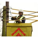 Overhead line shrouding manufactured from yellow U.V. resistant material